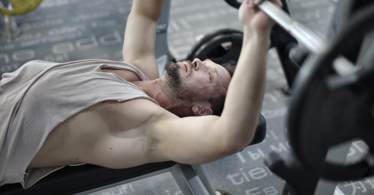 My items from chest has dissapeared, WHY? - From above view of strong bearded sportsman in sportive tank top concentrating during bench press with barbell while training in modern fitness club My items from chest has dissapeared, WHY? - From above view of strong bearded sportsman in sportive tank top concentrating during bench press with barbell while training in modern fitness club