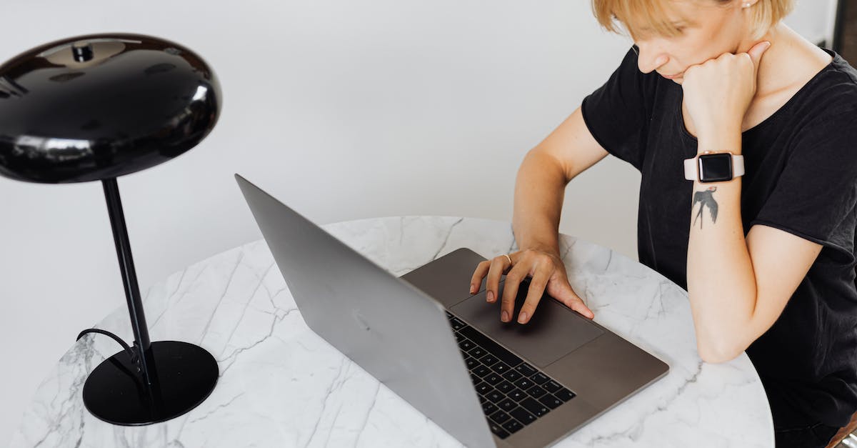 My laptop can't run Watch Dogs [closed] - Woman Sitting by Table with Laptop