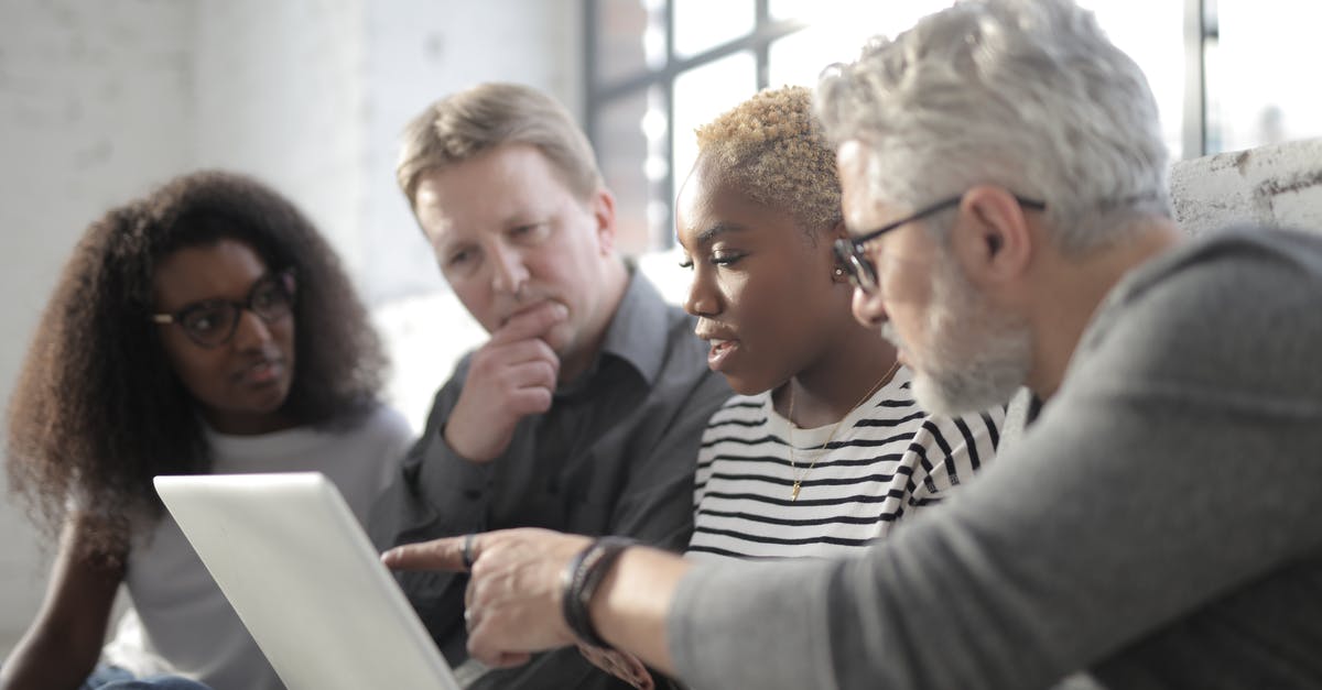 my minecraft is unable to show coordinates and im using windows 8 dell computer [duplicate] - Middle aged employee in eyeglasses pointing at netbook screen with finger while sitting near multiracial pensive colleagues near window in afternoon