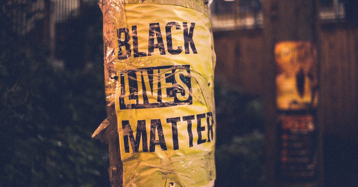 My nobles won't support a law [duplicate] - Inscription of protest movement saying black lives matter on pole in city street in evening