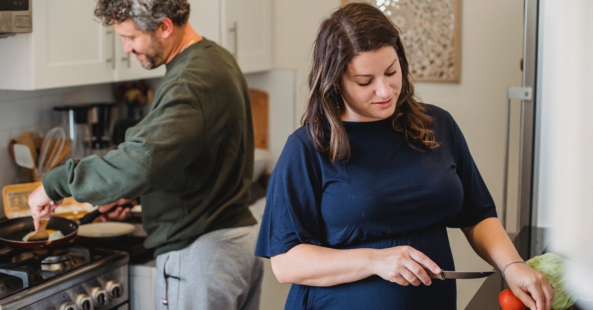 My wife disappeared, but we're still married. How can I fix this? - Cheerful couple cooking dinner in kitchen