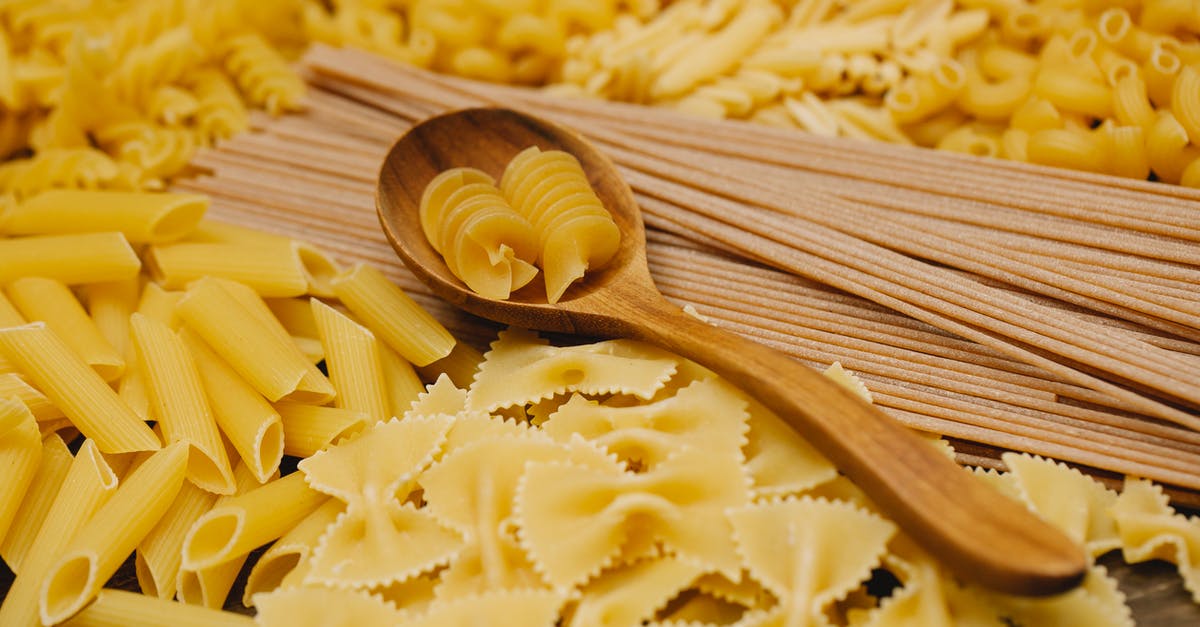 Name of the recipe for this type of wall? - Different types of raw pasta with wooden spoon