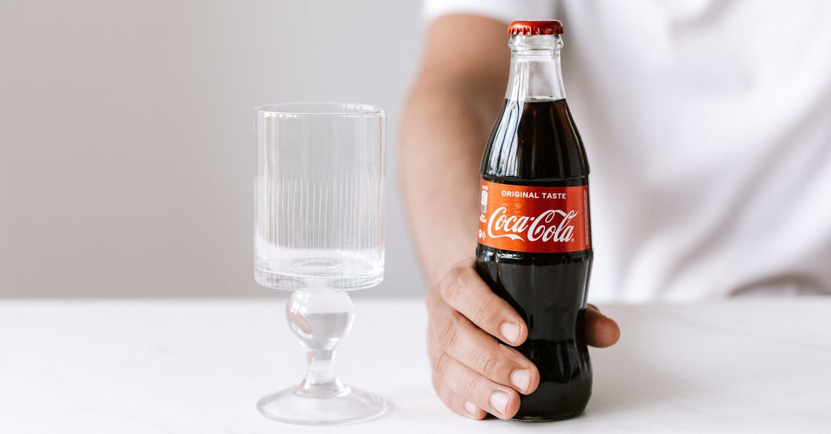 Nearby tracker doesn't refresh - Crop unrecognizable young guy in white t shirt demonstrating bottle of cold coke