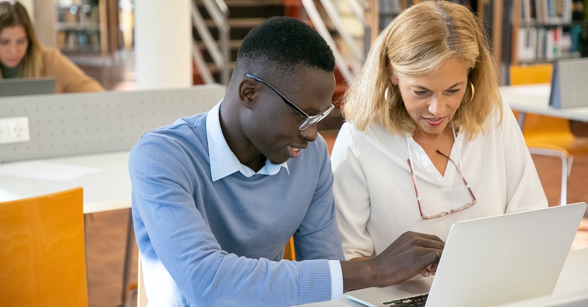 Need help getting multiplayer to work correctly in COD: Modern Warfare 2 - Female teacher helping ethnic male student working on laptop in library Need help getting multiplayer to work correctly in COD: Modern Warfare 2 - Female teacher helping ethnic male student working on laptop in library