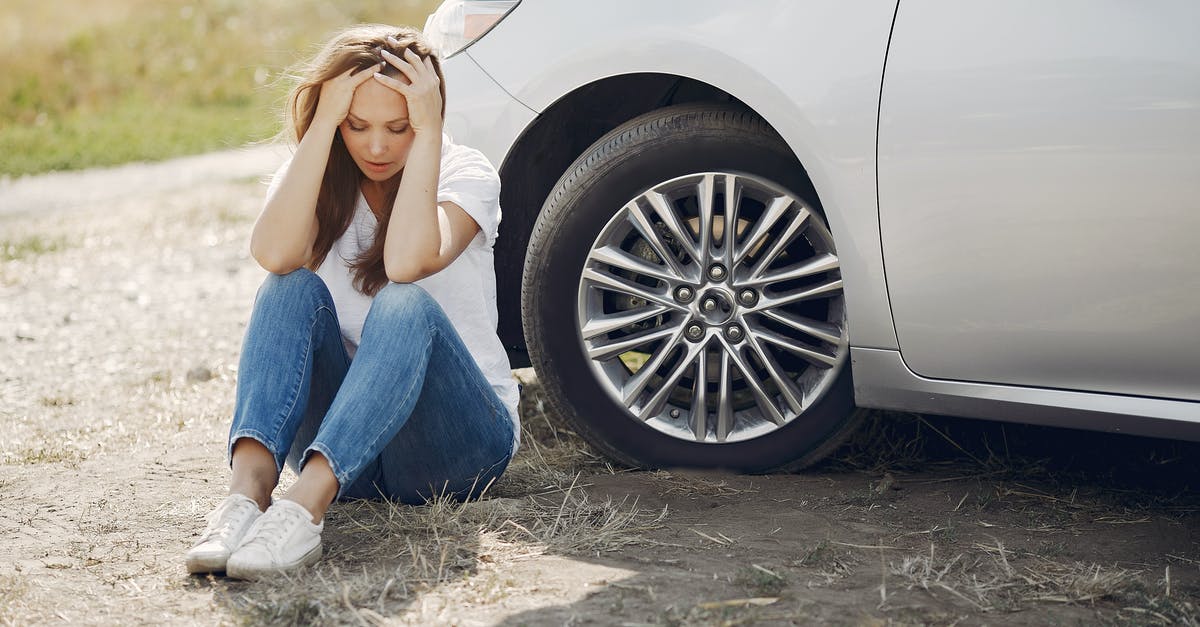 Need help on rocket boots - Frustrated female driver in white t shirt and jeans sitting on ground near damaged car with hands on head during car travel in sunny summer day Need help on rocket boots - Frustrated female driver in white t shirt and jeans sitting on ground near damaged car with hands on head during car travel in sunny summer day