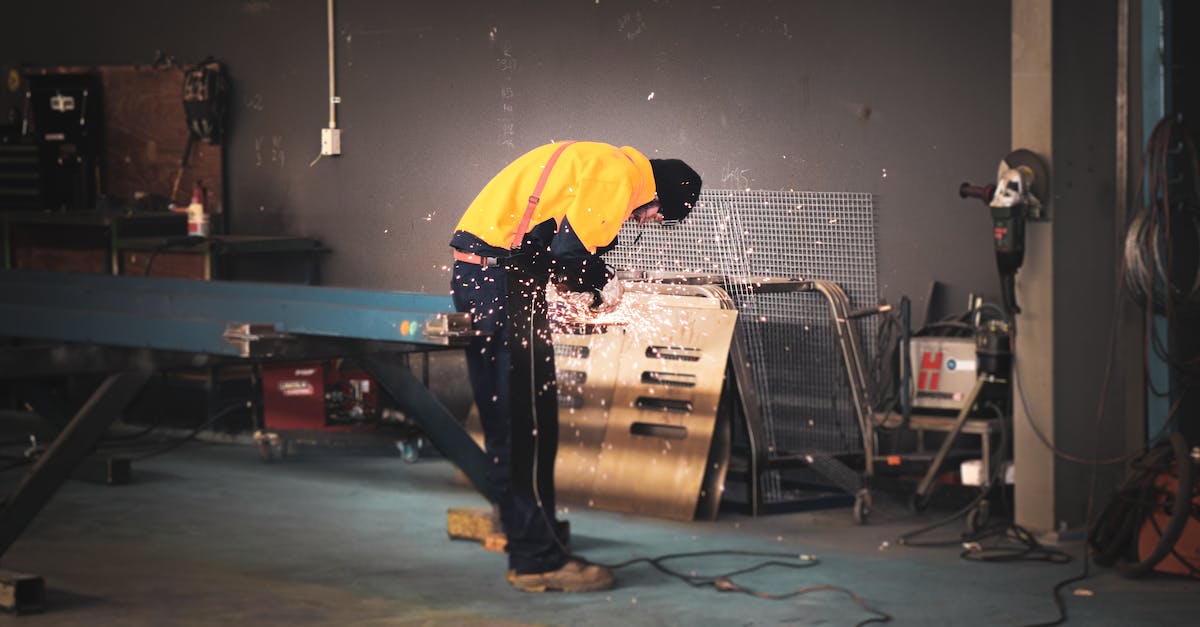 Nethack grinding for level 14 - Man in Yellow Shirt and Black Pants Standing Near Gray Metal Table
