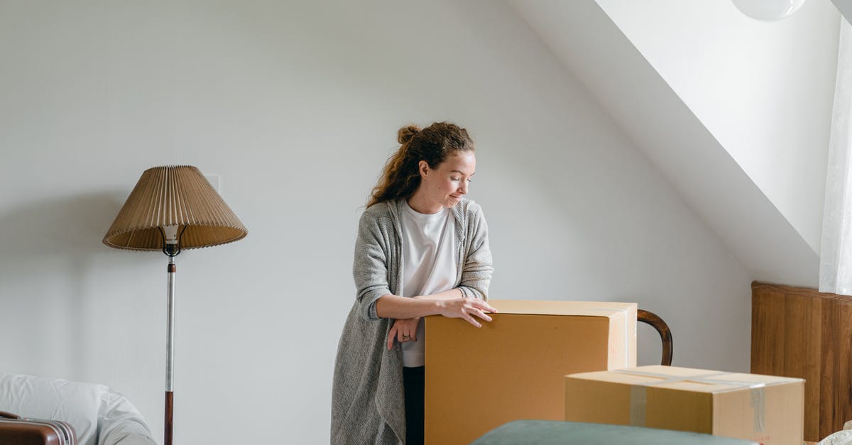 New HDD for my PS3 Super Slim 12 GB - Ponder woman standing leaned on big box at home