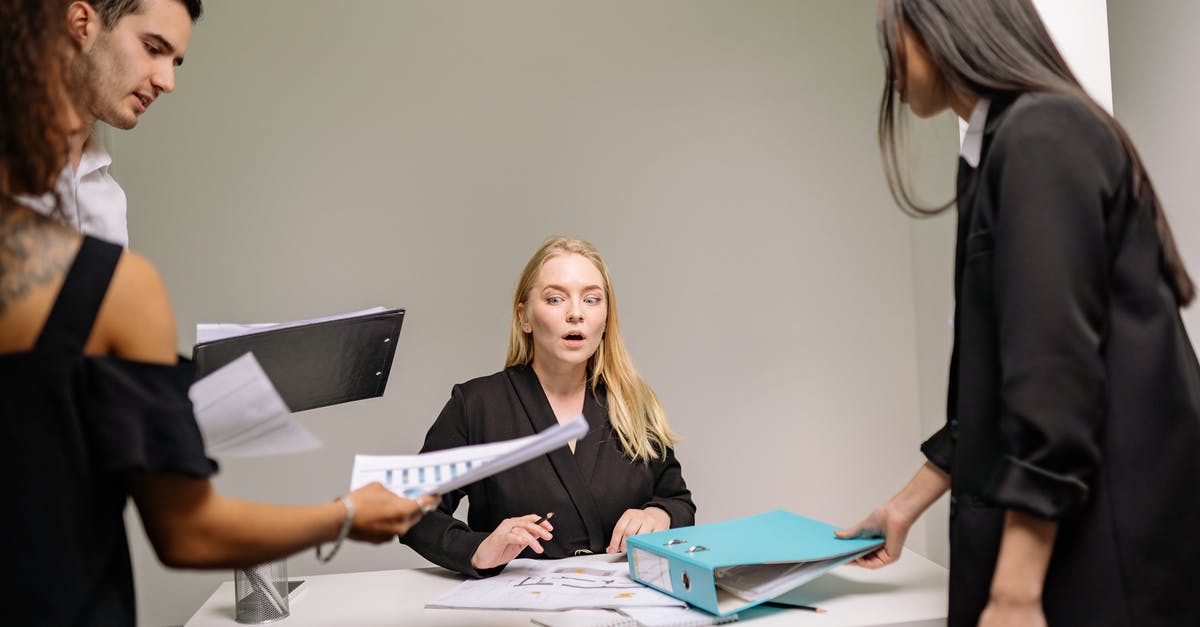 Nexus Mod Manager and Archive Files - A Woman in Black Blazer Sitting at the Desk with Documents
