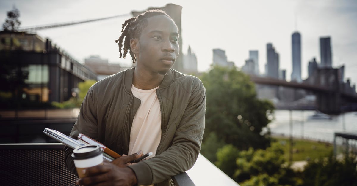No Man's Sky - All Black Holes Created Equal? - Dreamy African American student with dreadlocks in casual clothes standing leaned on balcony fence with plastic glass of coffee and organizer while contemplating river and looking away in morning No Man's Sky - All Black Holes Created Equal? - Dreamy African American student with dreadlocks in casual clothes standing leaned on balcony fence with plastic glass of coffee and organizer while contemplating river and looking away in morning
