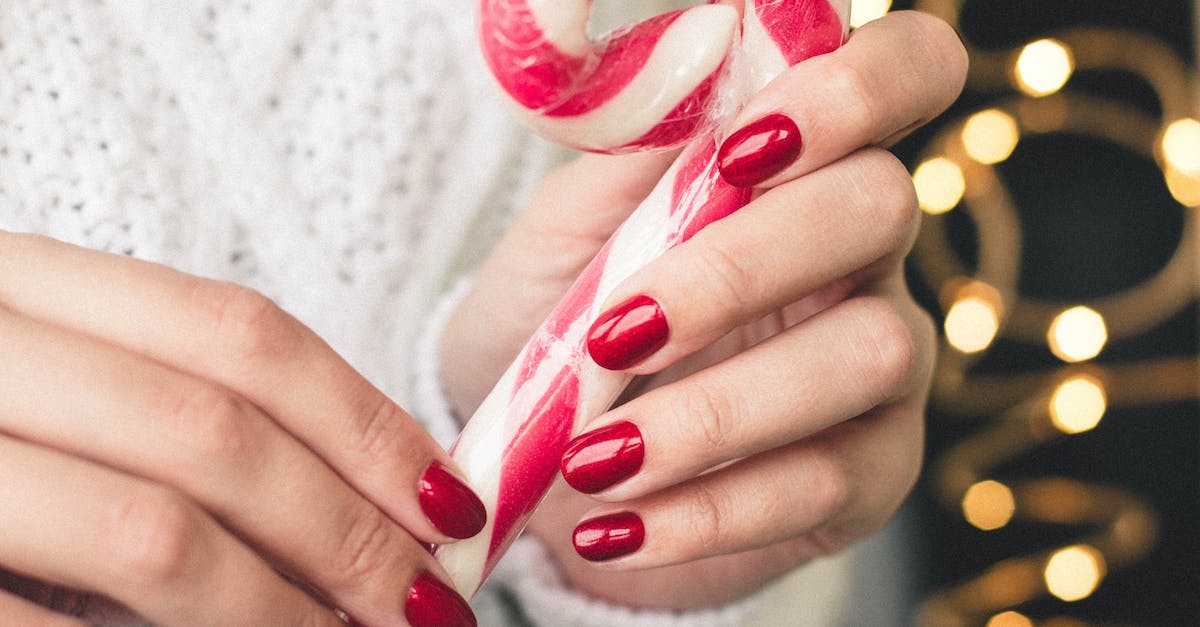 No more sugar canes [closed] - Close-Up Photo of Person Holding Candy Cane