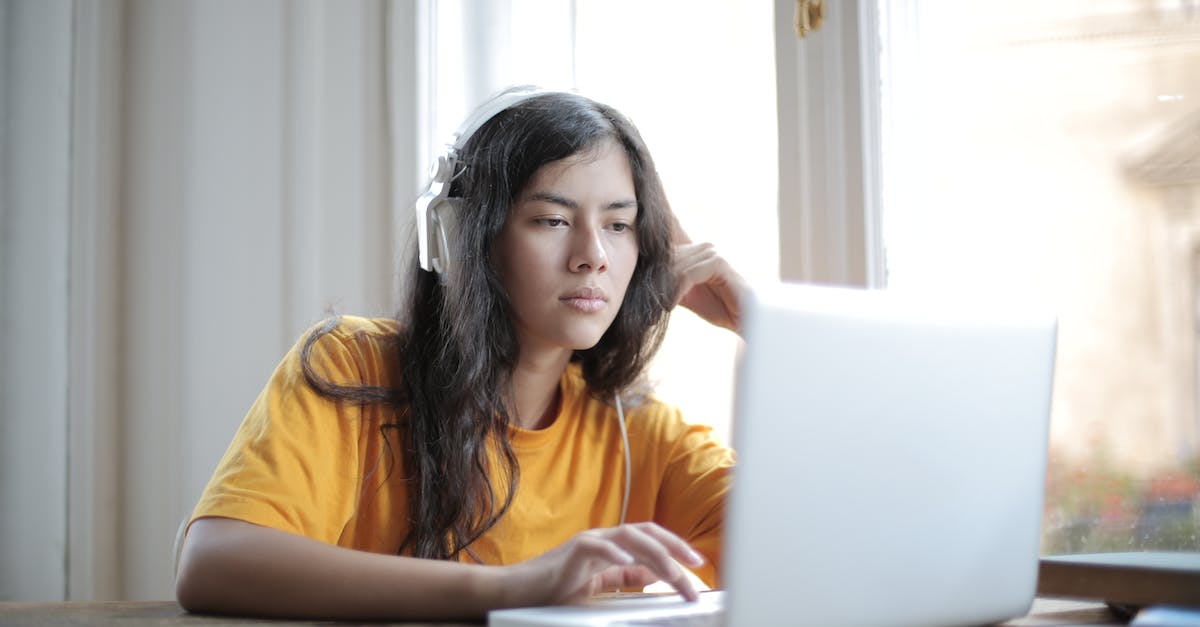 No music in Hotline Miami 1 on Mac - Woman in Yellow Crew Neck T-shirt Using Macbook Air on Brown Wooden Table