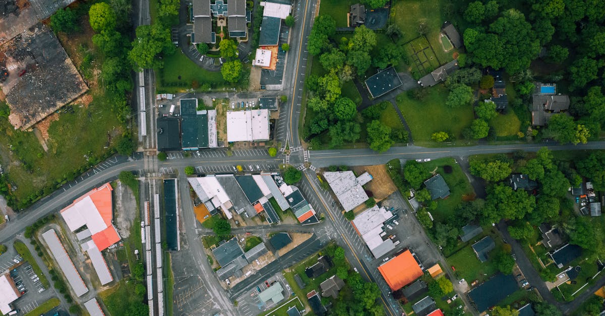 No pokemon in remote rural areas? [duplicate] - Aerial view suburban area with residential cottages and commerce buildings