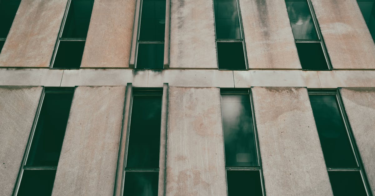 No stained glass? - A Brown Concrete Building with Glass Windows and Stained Wall No stained glass? - A Brown Concrete Building with Glass Windows and Stained Wall