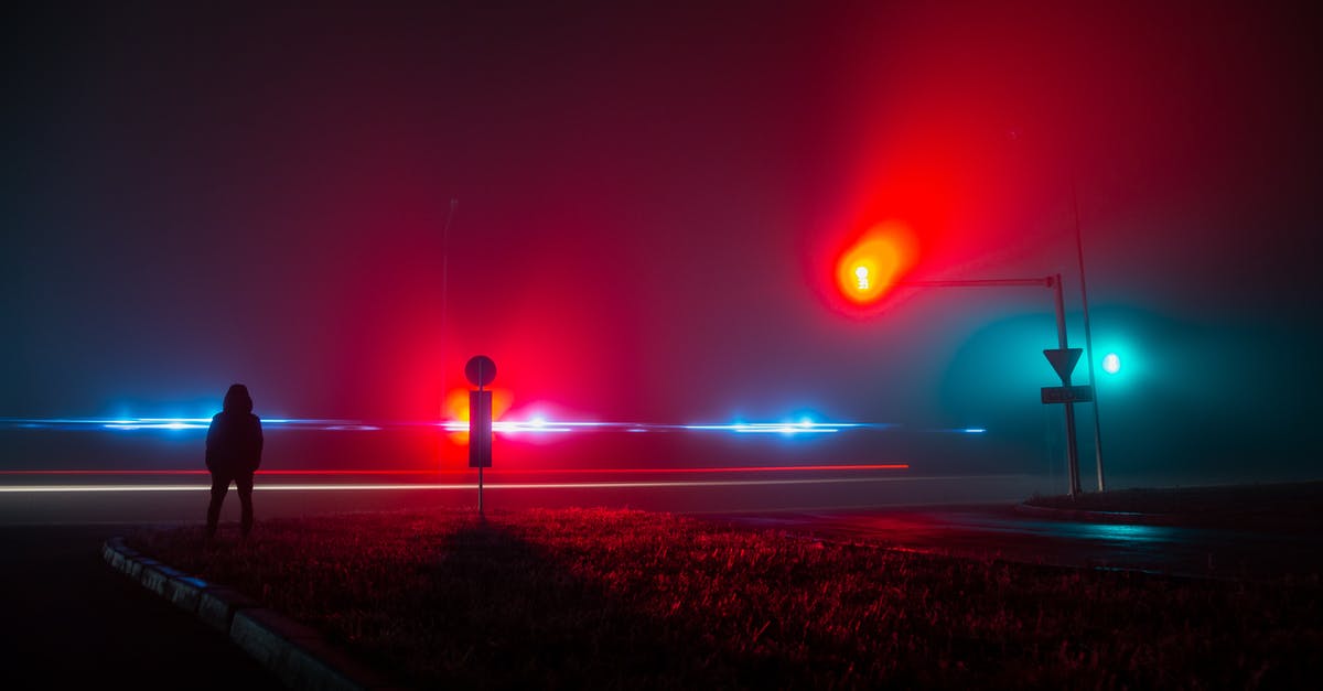 No UFO sightings and landings? - Unrecognizable Person Observing Red and Blue Lights on Road at Night No UFO sightings and landings? - Unrecognizable Person Observing Red and Blue Lights on Road at Night