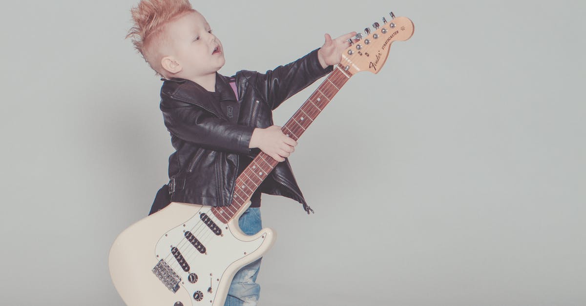 Non Anonymized Theme - Boy Wearing Black Jacket Holding Electric Guitar