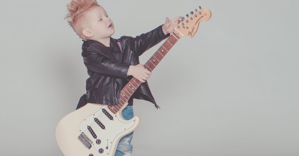 Non Anonymized Theme - Boy Wearing Black Jacket Holding Electric Guitar Non Anonymized Theme - Boy Wearing Black Jacket Holding Electric Guitar