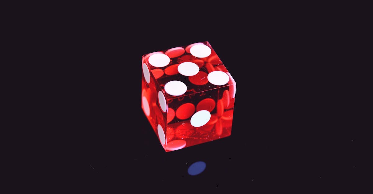 Noore had to die thrice - Red Translucent Die on Top of Black Surface Noore had to die thrice - Red Translucent Die on Top of Black Surface