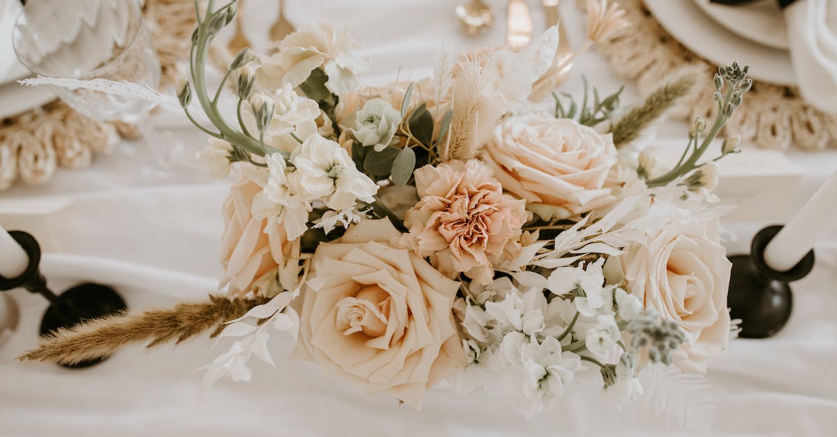 NPC Disappearance during Marriage Event - Top view of delicate bunch of fresh flowers and branches decorating festive wedding table with dishware and candlesticks