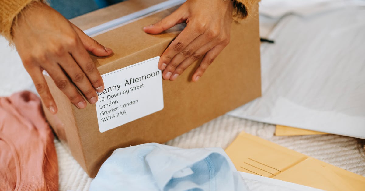 Number next to a Guardian's name? - Woman preparing box with parcel for sending