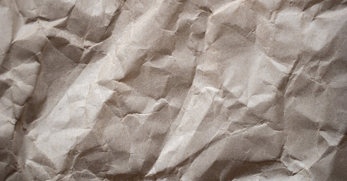 Obsolete Material - Textured background of crumpled thick paper surface of light brown color in daylight Obsolete Material - Textured background of crumpled thick paper surface of light brown color in daylight