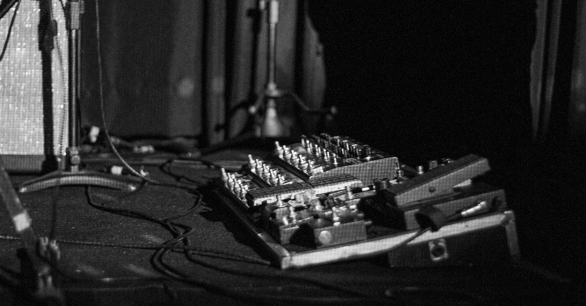 Old controller not connecting - Black and white of retro mixing console with rows of knobs and faders against mics with wires