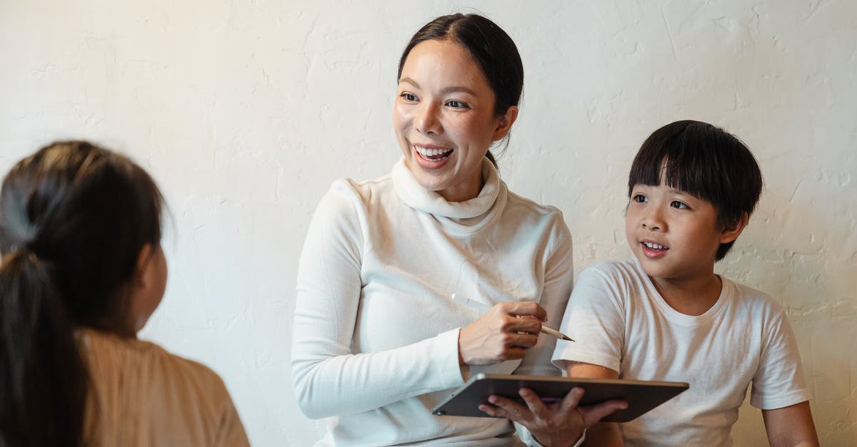 One son used other sons gmail account [duplicate] - Glad female in casual clothes sitting with tablet and pen near adorable son and crop unrecognizable daughter in house while looking at each other