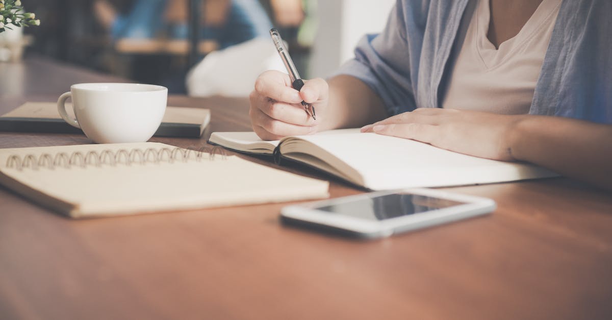Online Hacking not working - Woman Writing on a Notebook Beside Teacup and Tablet Computer