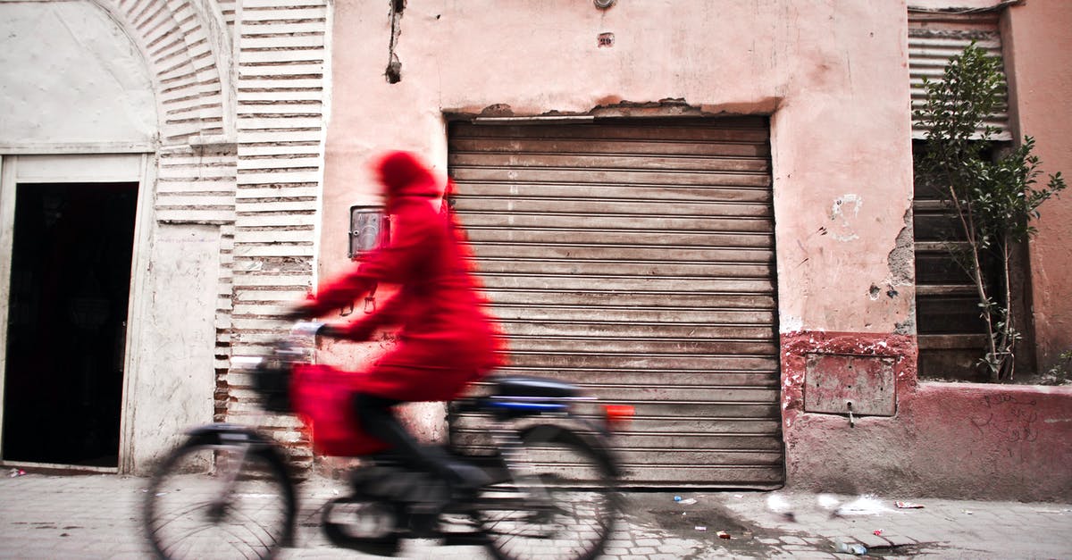 Only fast travel to houses or festival? - Woman in Red Coat Using Bicycle