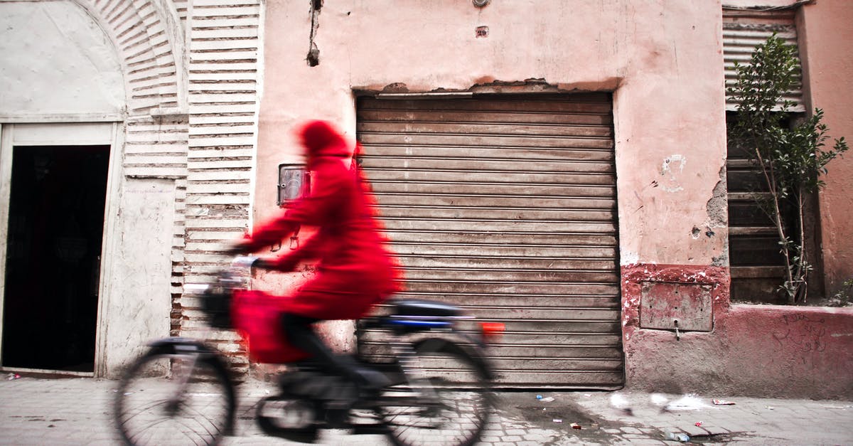 Only fast travel to houses or festival? - Woman in Red Coat Using Bicycle Only fast travel to houses or festival? - Woman in Red Coat Using Bicycle