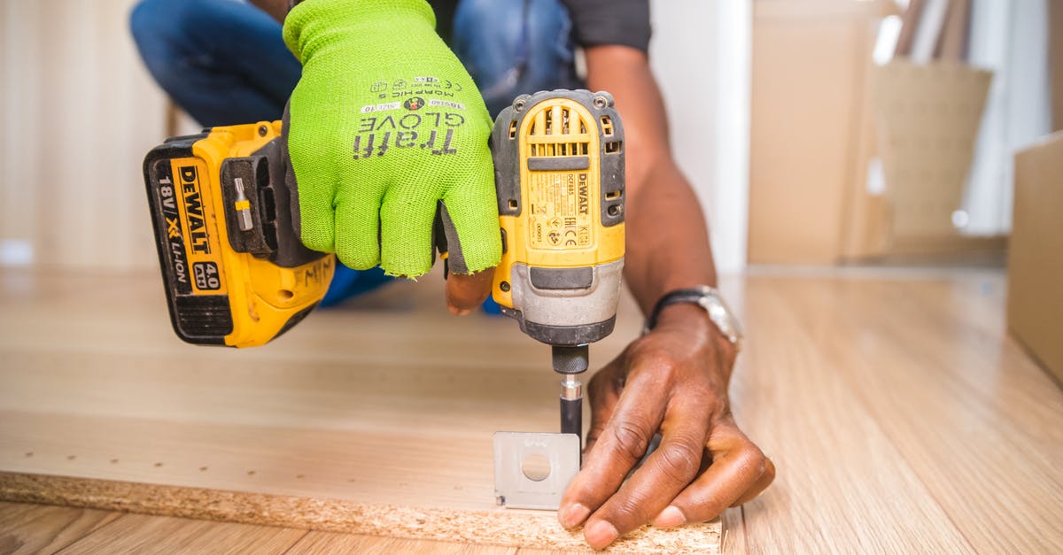 Optimal Drill Placement for Tunneling w/Rovers - Person Using Dewalt Cordless Impact Driver on Brown Board