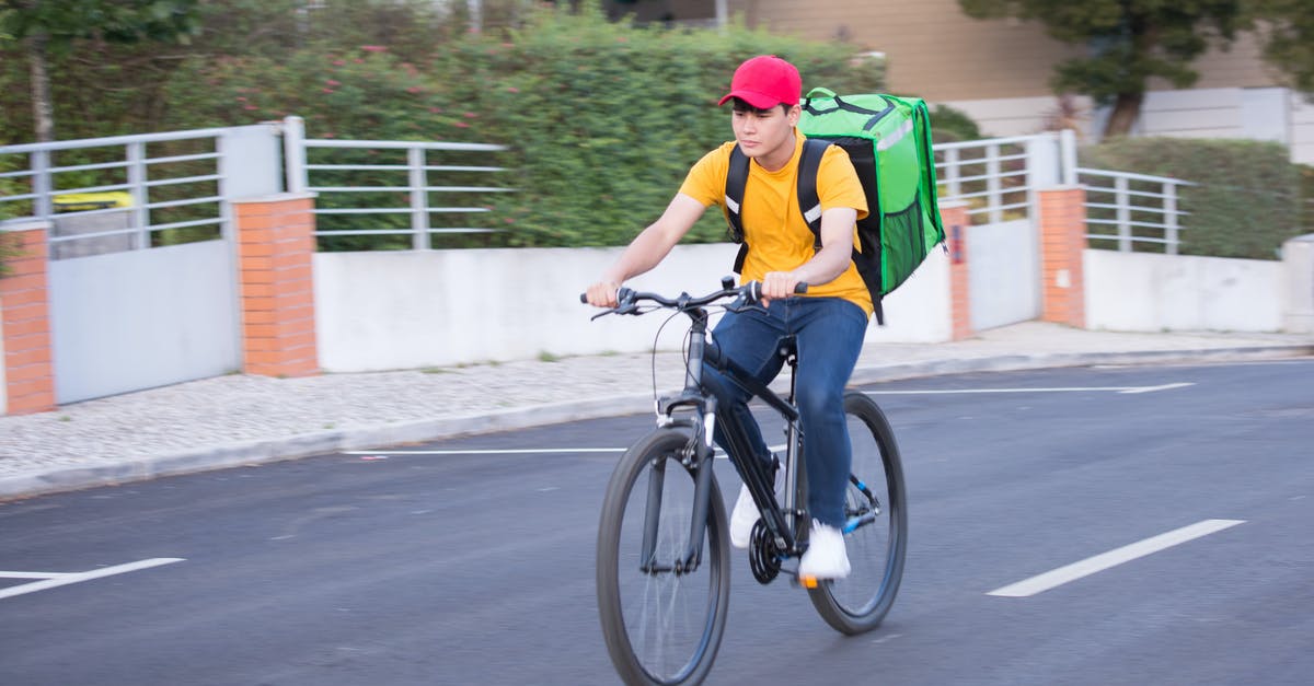 Order of defending Pokemon - Man in Green Shirt Riding on Black Bicycle on Road