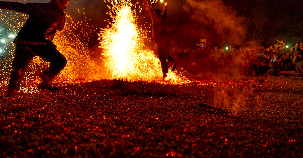 Order squad mates to activate electronics skill in Mass Effect 1 - Back view of anonymous male dancing on fire show in nature in evening time