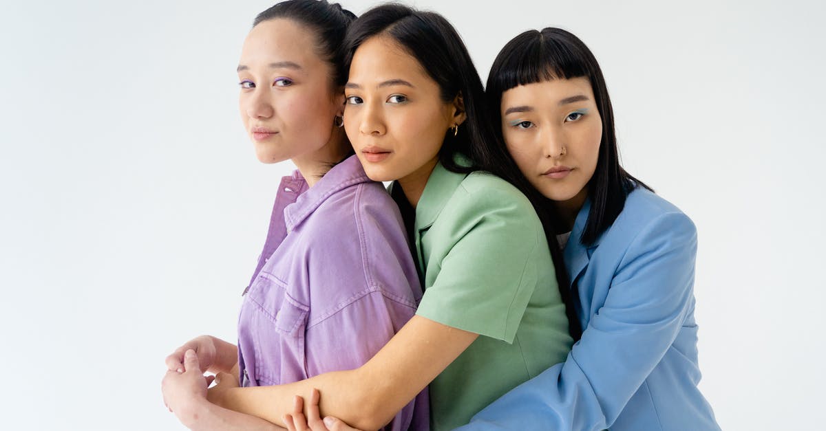 Outfits disappeared - Woman in Blue Dress Shirt Hugging Woman in Pink Dress Outfits disappeared - Woman in Blue Dress Shirt Hugging Woman in Pink Dress