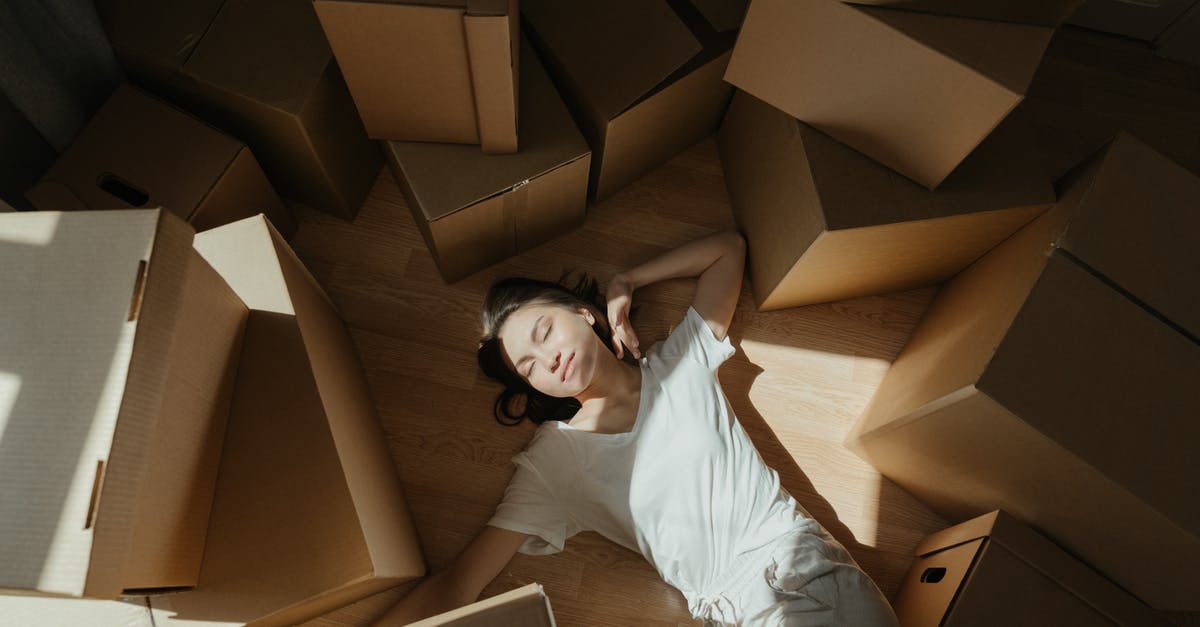 Overwatch Origin skins from loot boxes - Woman in White Long Sleeve Shirt Lying on Brown Cardboard Box