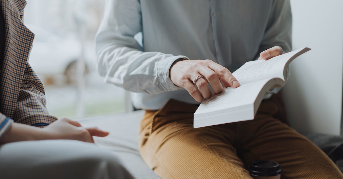 Palico quest explanation - Man in White Dress Shirt and Brown Pants Sitting on White Chair Reading Book Palico quest explanation - Man in White Dress Shirt and Brown Pants Sitting on White Chair Reading Book