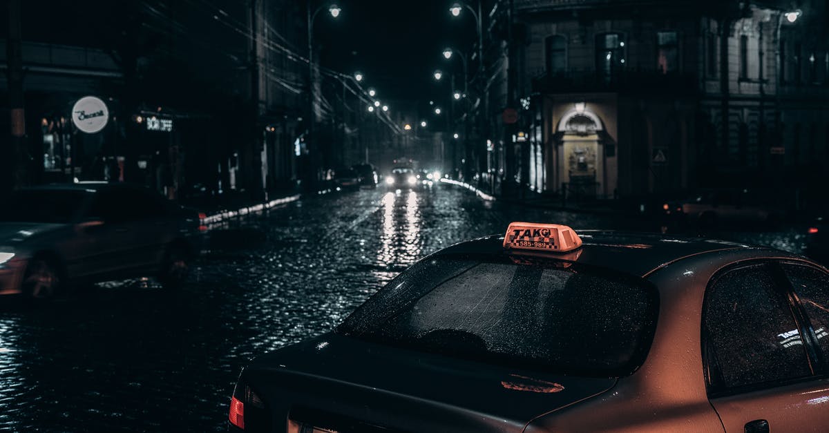 Parks in industrial areas? - Taxi placed on street in rainy evening
