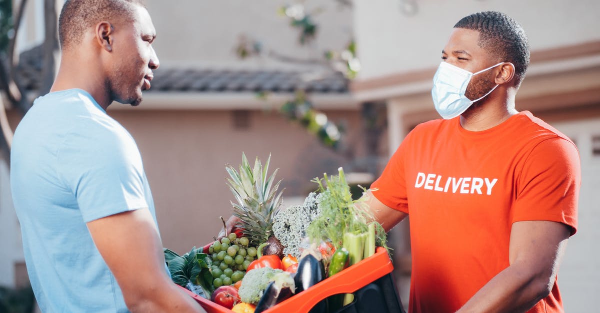 Pause the mayhem in Super Crate Box - A Man Holding a Plastic Crate Full of Vegetables and Fruits