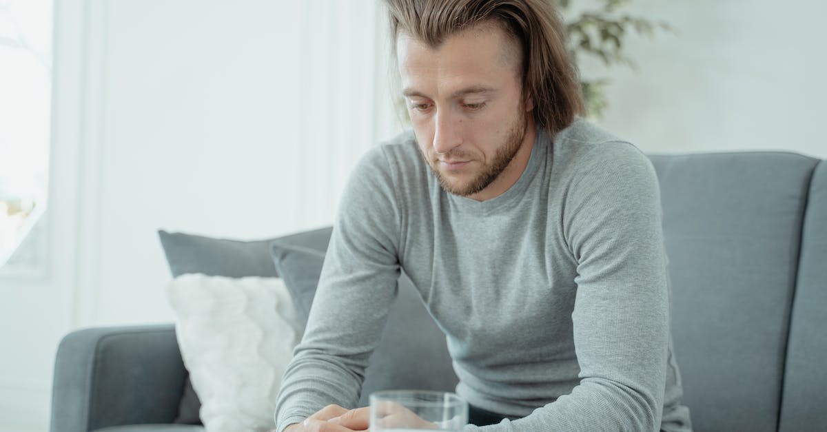 People going around on a couch - Woman in Gray Long Sleeve Shirt Sitting on White Couch People going around on a couch - Woman in Gray Long Sleeve Shirt Sitting on White Couch