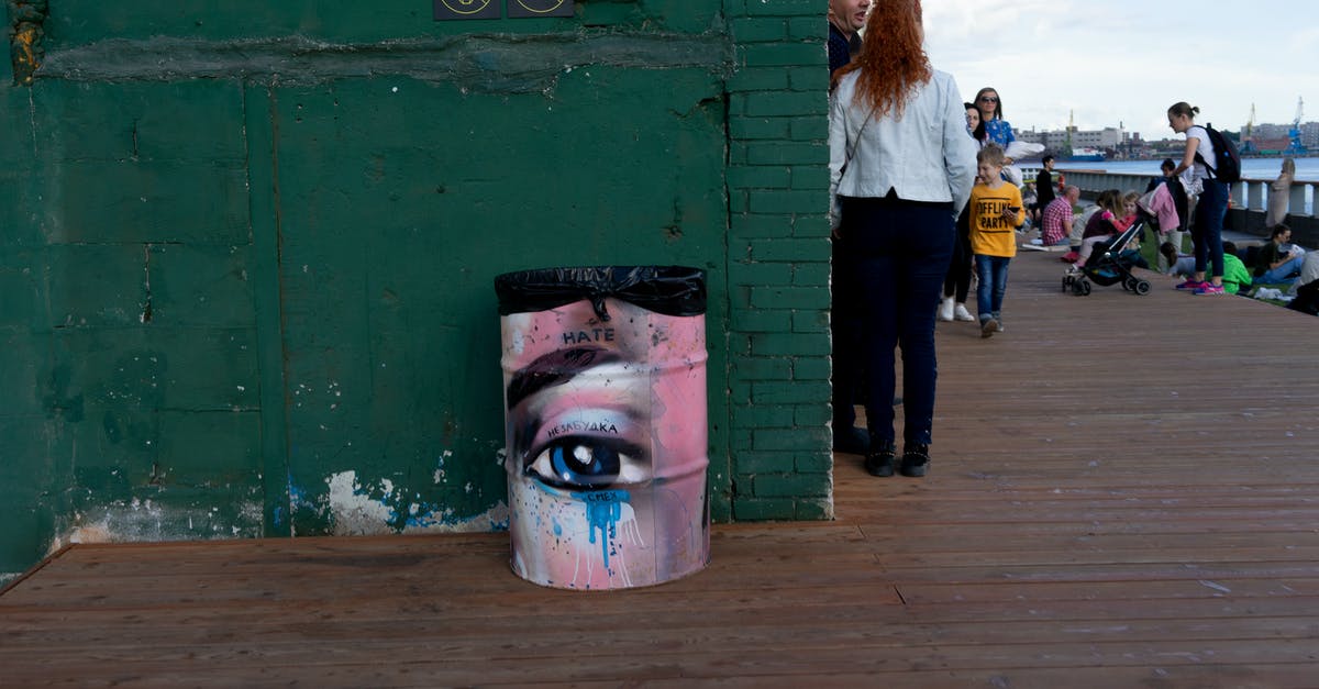 Person in distress near Mulbrydale (Velen): the master swordsmith refuses to move or talk after being freed from his cage - Group of people walking on wooden surface with brick building with forbidding sign and unusual bucket