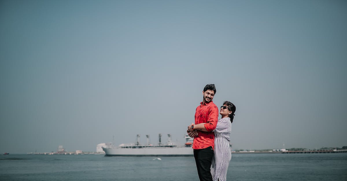 Piracy is okay: ship or augment? - Man in Red and White Plaid Dress Shirt and Black Pants Standing on Seashore