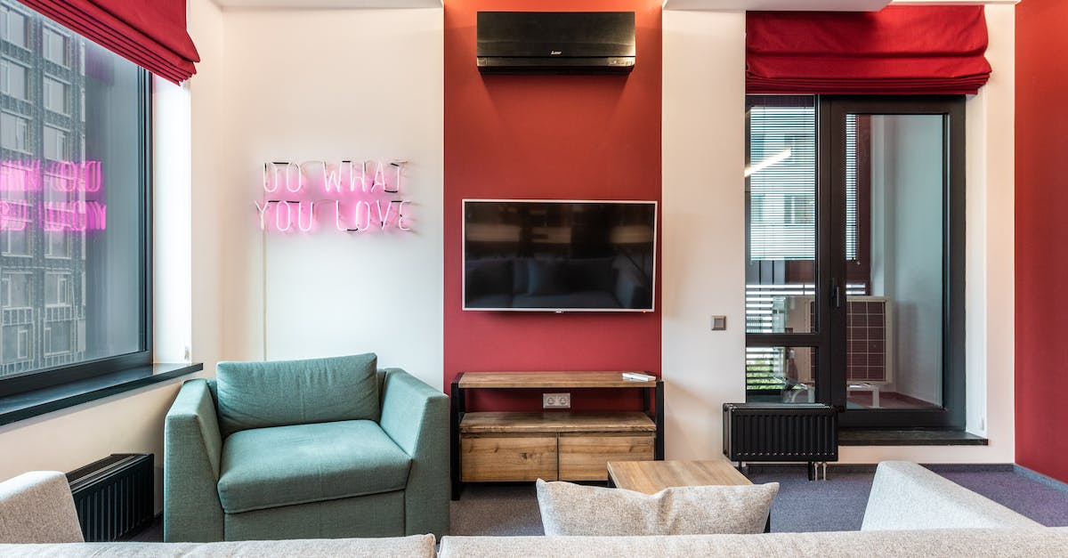 Pixel Poro - What do the gems / hearts do? - Interior of modern office lounge zone with sofa and armchair with table near window next to TV on wall and neon signboard with text do what you love near door