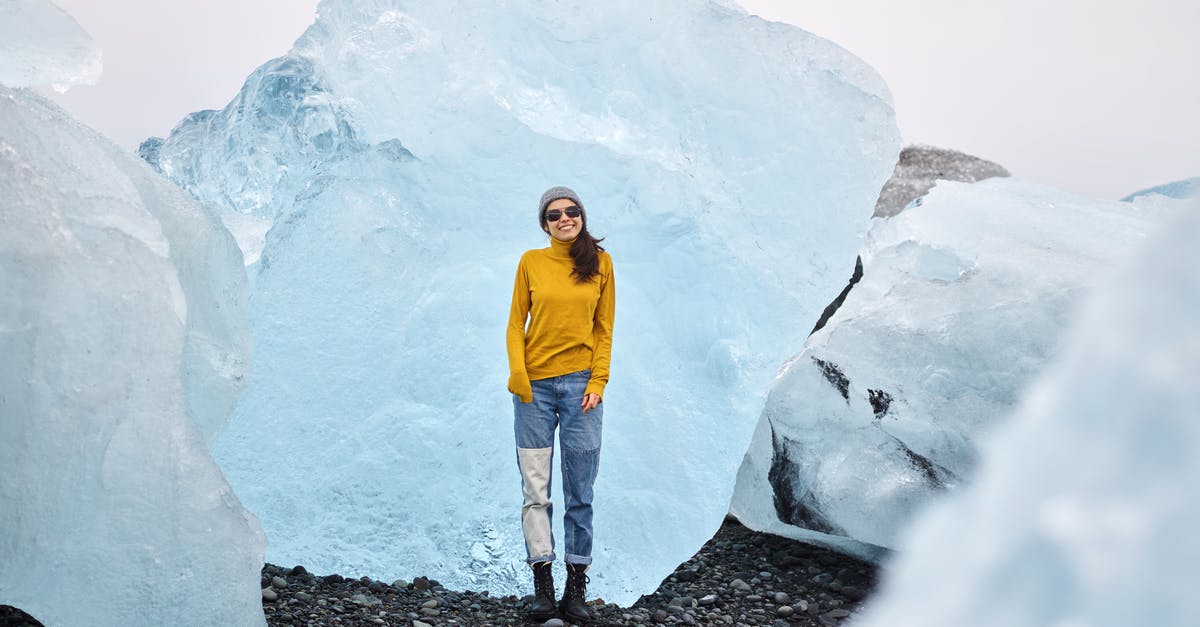 Place-able and breakable block in Adventure Mode [duplicate] - Cheerful young woman in sunglasses standing on rocky ground among multicolored huge ice blocks during trip to north