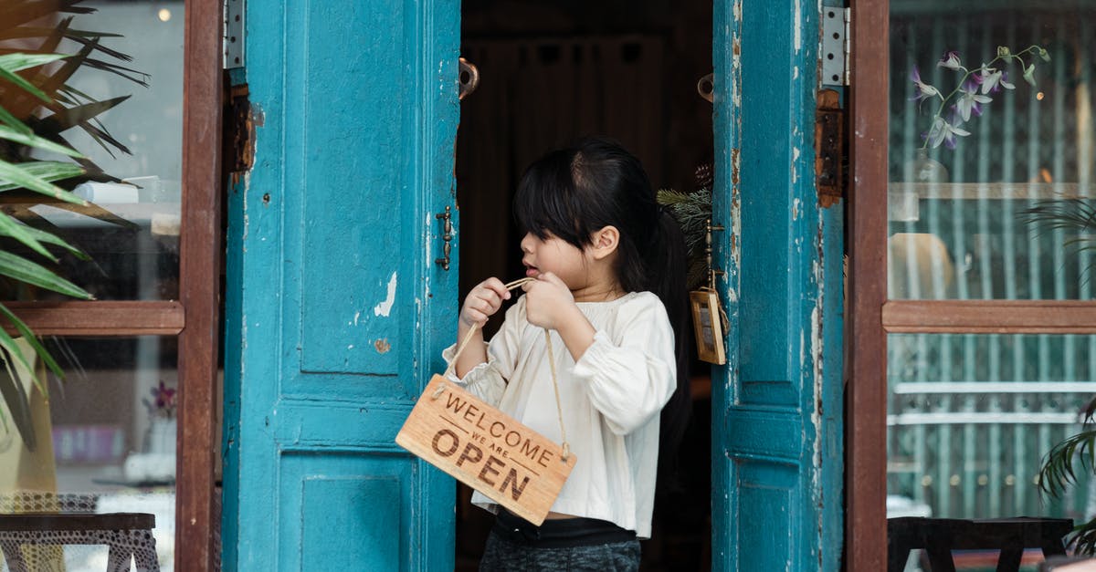 Placing a sign, given from a generator, not working - Photo of Girl Holding Wooden Welcome Signage While Standing on Doorway Placing a sign, given from a generator, not working - Photo of Girl Holding Wooden Welcome Signage While Standing on Doorway