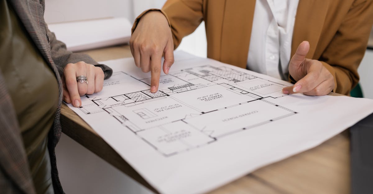 Planning and analyzing lighting layout - People Looking at Blueprints