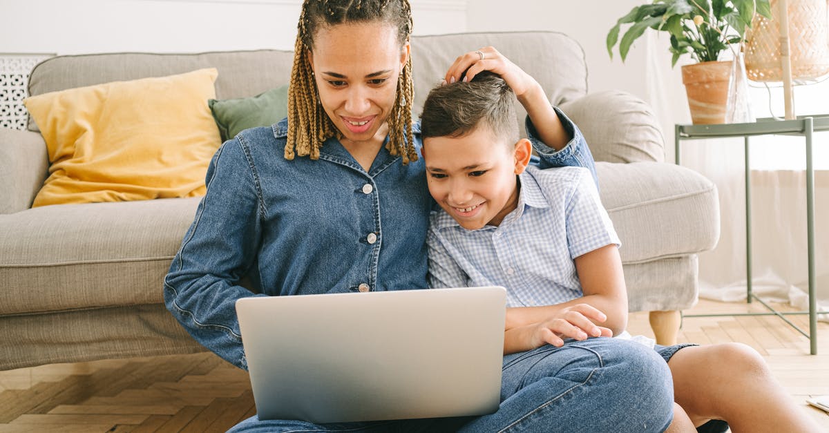 Play wwf in two different languages with two different people - Woman and Young Boy Sitting on Floor with Laptop