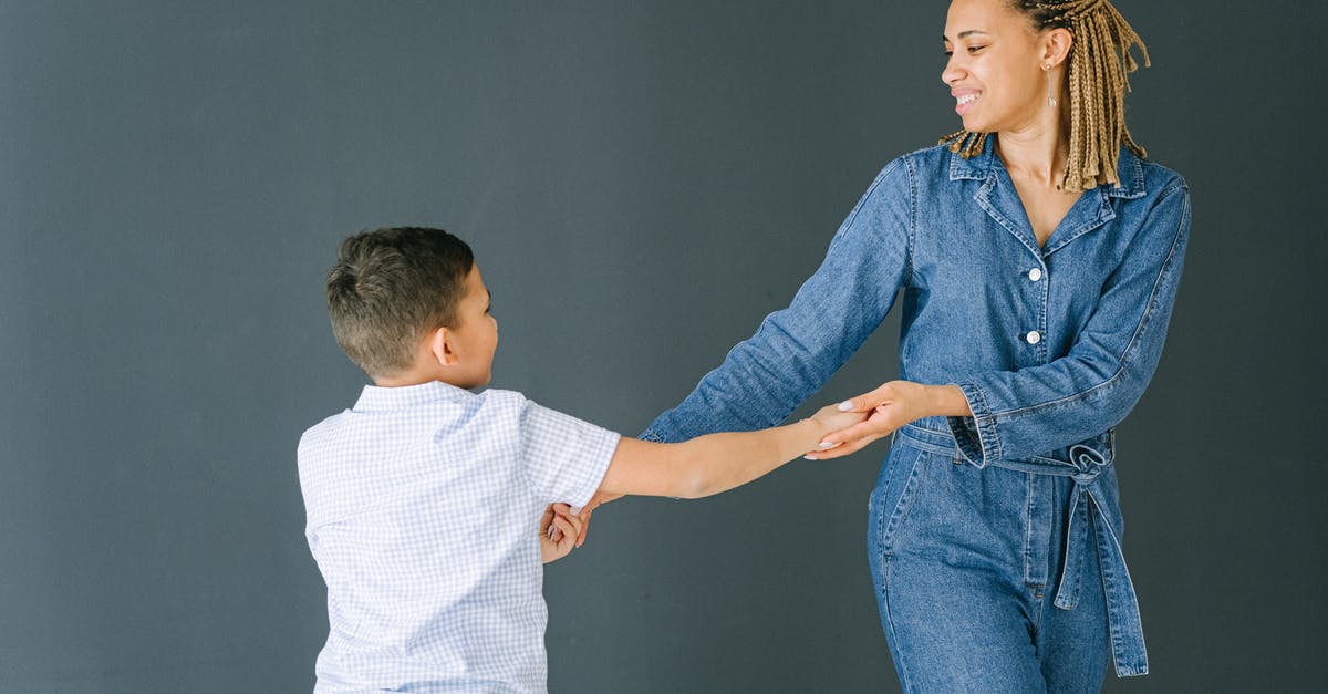 Play wwf in two different languages with two different people - Woman and Boy Holding Hands while Dancing Play wwf in two different languages with two different people - Woman and Boy Holding Hands while Dancing