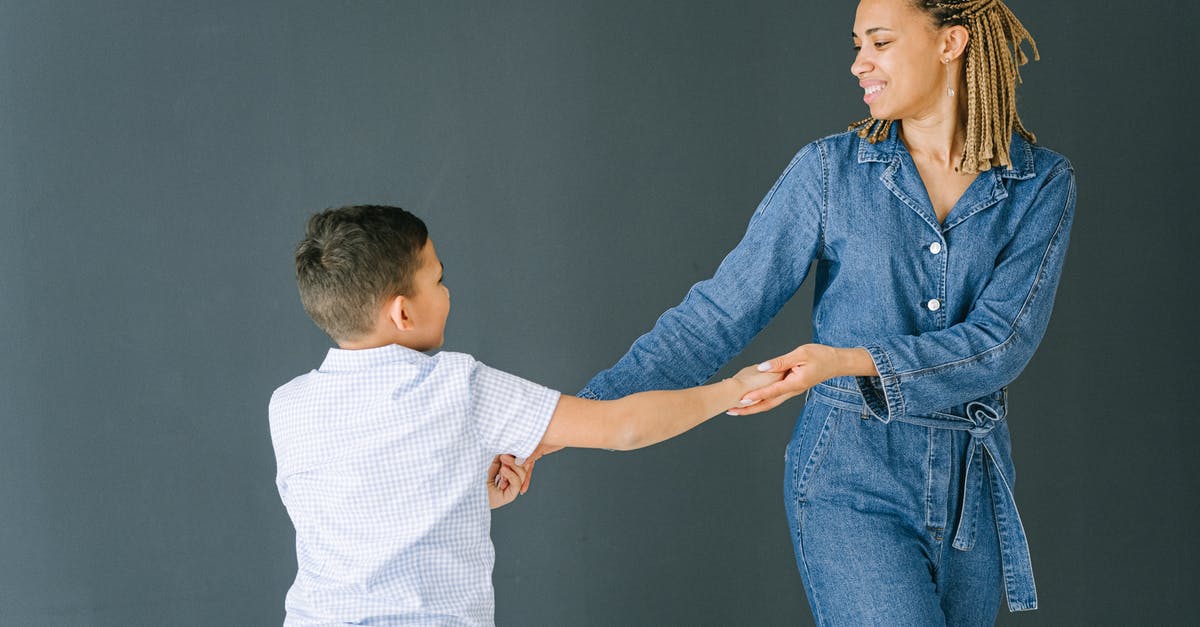 Play wwf in two different languages with two different people - Woman and Boy Holding Hands while  Dancing