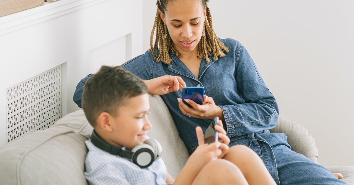 Play wwf in two different languages with two different people - Woman in Blue Denim Jacket Sitting Beside a Boy 