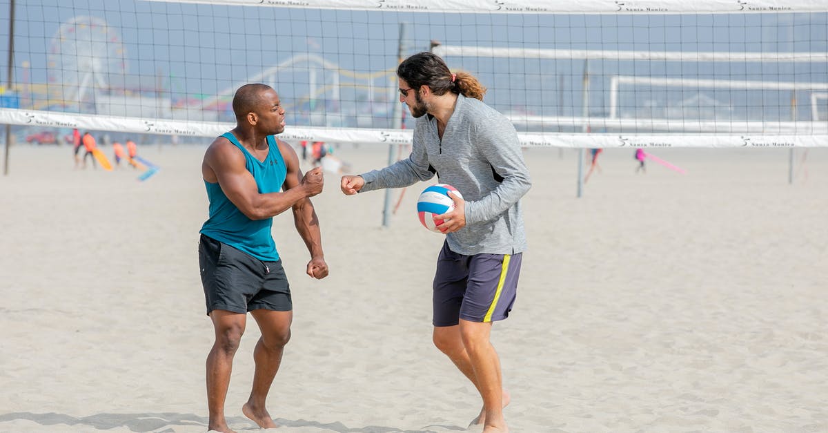 Players switching roles when making formation changes - Two Beach Volleyball Giving Fist Bump Gesture