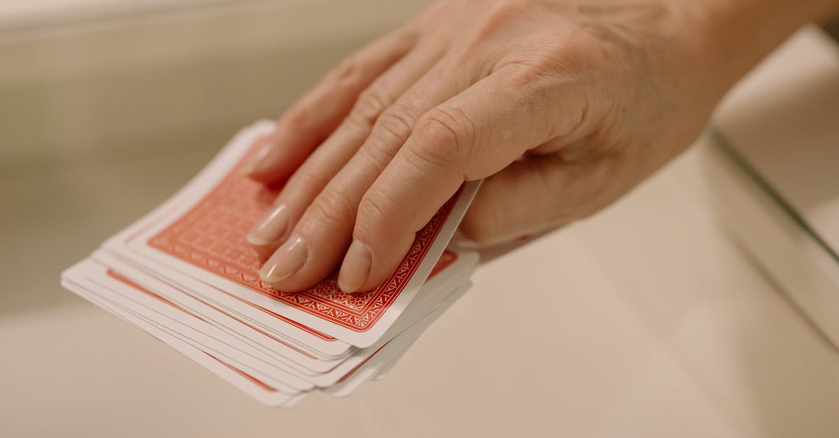 Playing An Item Card - A Person Picking a Gaming Card Playing An Item Card - A Person Picking a Gaming Card